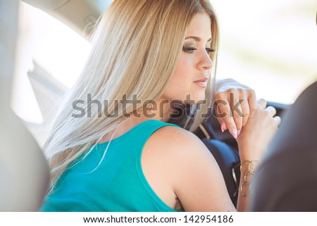 happy young woman in car smiling enjoying car road trip travel vacation. Driving. sexy lady driver with long blond healthy hair in automobile . spring - summer portrait