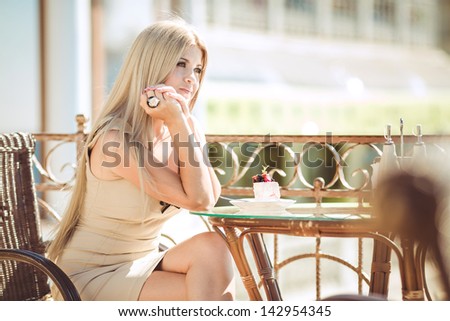 vintage beautiful woman in restaurant cafe with tiramisu cake and coffee.Healthy food drink for breakfast.Stylish rich slim girl in retro dress.glamorous lady at vacation. Retro style.France.series
