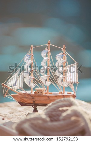 ship ropes lantern on a wooden background board with other sailor things around