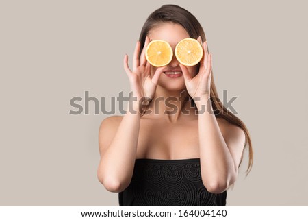 Close up portrait of young emotional beautiful woman with lemon in her hands. Perfect skin! Isolated