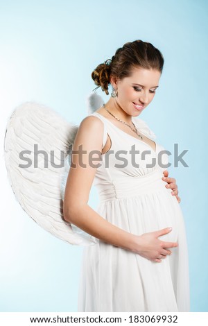 Portrait of a beautiful angelic pregnant woman. Angel