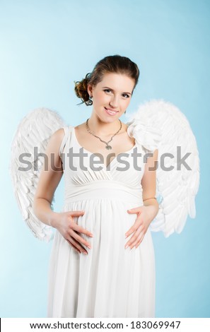 Portrait of a beautiful angelic pregnant woman. Angel