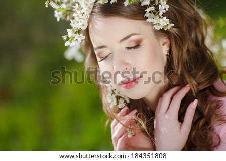 Sensual portrait of a spring woman, beautiful face female enjoying cherry blossom, dreamy girl with pink fresh flowers outdoor, seasonal nature, tree branch and glamorous lady