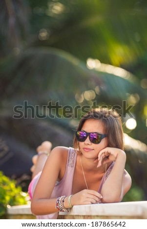 Summer girl portrait. Asian woman smiling happy on sunny summer or spring day outside in park by lake. Pretty mixed race Caucasian young woman outdoors.