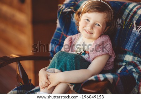 beautiful young girl portrait playing outdoors on wooden terrace