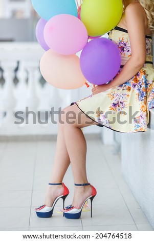Happy beautiful bride with colorful latex balloons, outdoors. Happy young woman with big colorful latex balloons. Outdoors, lifestyle.