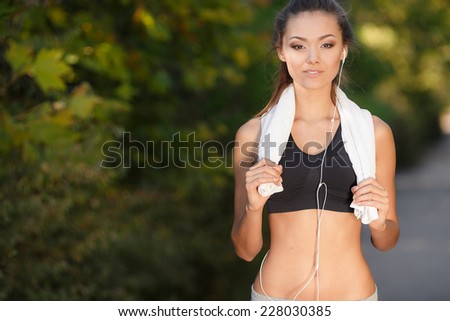 fitness and lifestyle - portrait of a beautiful young woman after/before training in park