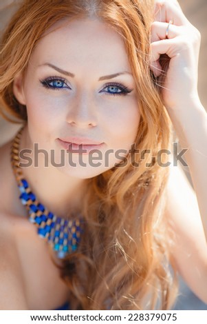 Portrait Of Young Smiling Beautiful Woman. Stunning young woman posing outdoor over brick wall. Portrait of a beautiful woman