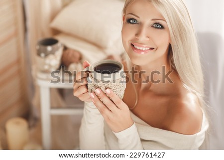 Soft photo of woman on the bed with old book and cup of coffee in hands, top view point. Cozy, comfy, soft  Home portrait of beautiful young woman, selective soft focus