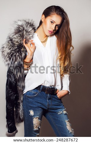 fashion studio photo of beautiful sensual woman with long dark hair in luxurious fur coat. fashion studio portrait of beautiful sensual woman with blonde hair in luxurious fur coat.