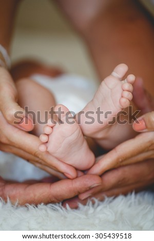 newborn baby feet on female hands. Baby feet in mother hands. A close-up of tiny baby feet. newborn baby feet. Baby feet in mommy\'s hands