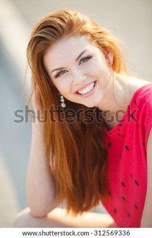 Woman with white teeth tin a park in summer. beautiful young woman. Beautiful woman face. smile. Portrait Of Young Smiling Beautiful Woman