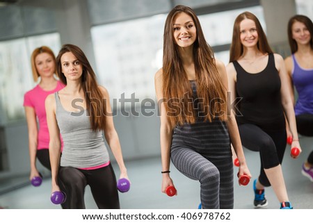 Group of fit people at the gym exercising. Group of people in pilates class doing sportrs on fit balls at gym. group of gym people in an aerobics class