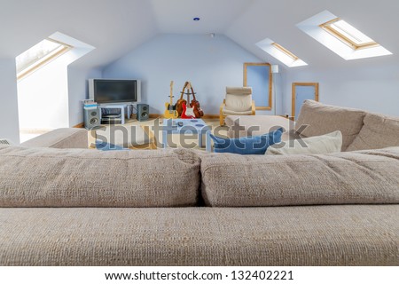 a loft with a sofa and a flat screen tv