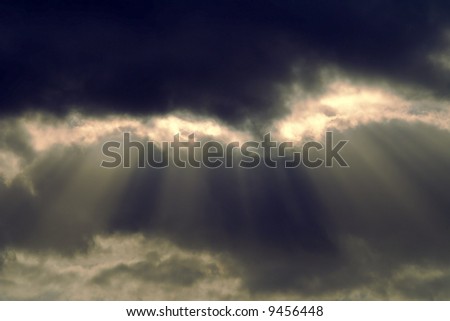 A cloudscape in the sky with clouds and shafts of light.