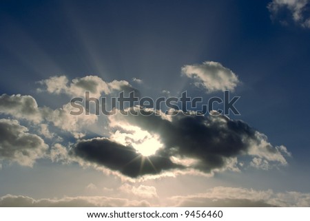 A cloudscape in the sky with clouds and shafts of light.