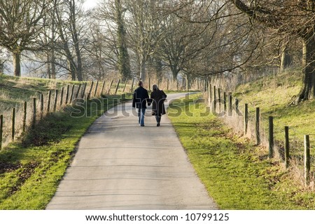 A couple walking in the countryside.
