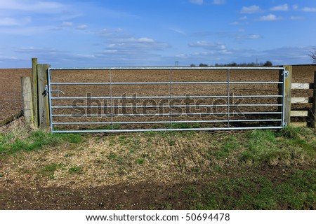 a sunlit gate - the entrance to a field