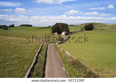 peak district landscape with fields and dry stone walls - view from the tissington trail cycle path and footpath