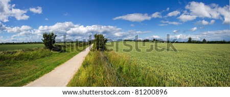 the greenway - disused railway line now a cycleway. stratford upon avon warwickshire. agricultural fields and farmlnad on either side.