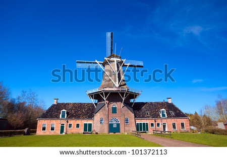 big Dutch windmill over blue clear sky