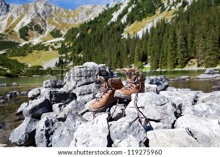 leather hiking shoes on stone  in Alps