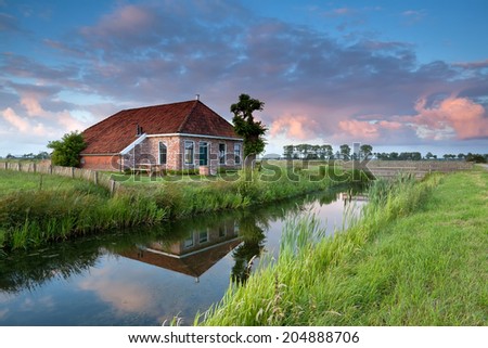 beautiful cozy farmland by river at sunset, Netherlands