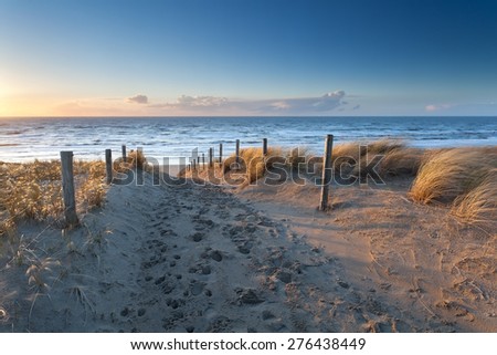 sand path to North sea coast at sunset, Holland