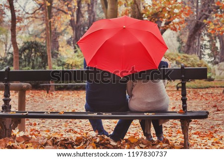 love, happy elderly couple in love, retired people enjoying romantic moment in autumn park, fall season