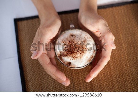 a cup of coffee in hands