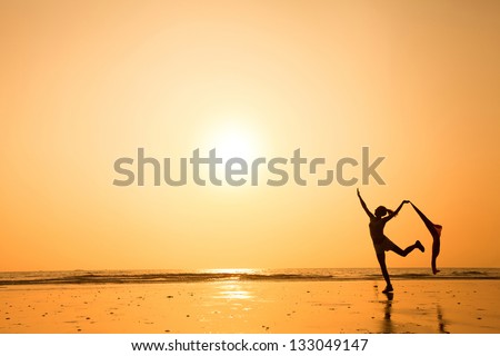 dancing woman at sunset on the beach dancing woman at sunset on the beach