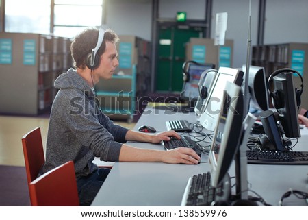 student working at the computer in the library