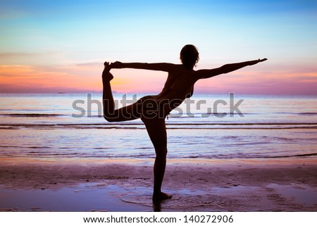 silhouette of young woman doing gym and stretch exercises on the beach