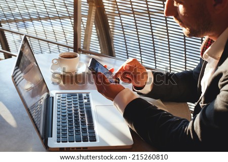 businessman using smartphone and laptop