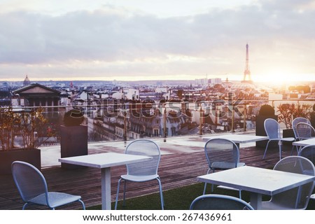 sunny terrace of restaurant in Paris with panoramic view on Eiffel tower, France