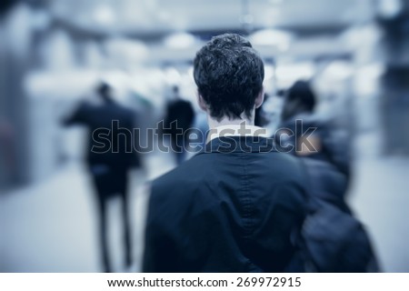 people walking in metro, blurred motion, back of the man