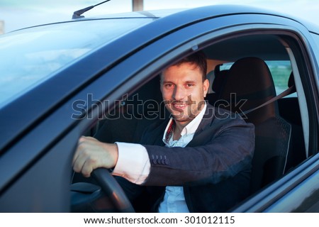 rent a car, smiling happy caucasian young man driving