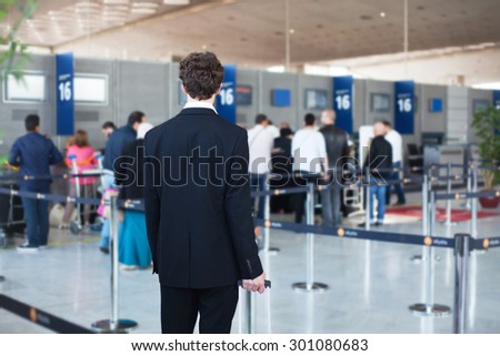 people at the airport, passenger waiting in queue to check in and drop off luggage
