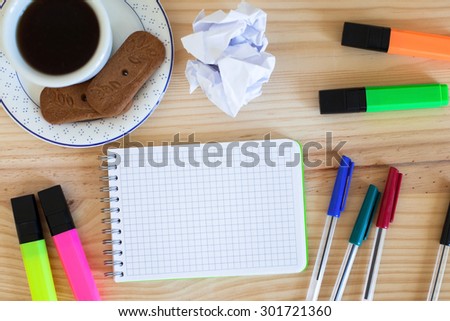 notepad and colorful markers on the table, top view