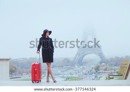 tourist in Paris, Europe tour, woman with luggage near Eiffel Tower, France