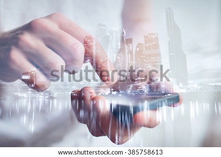man hands touching smartphone, closeup, double exposure with modern city skyline