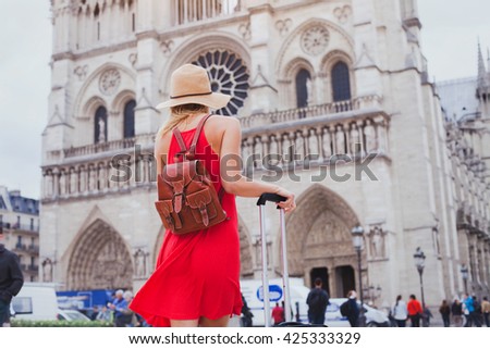 travel in Europe, gothic architecture of catholic church, tourist looking at Notre Dame cathedral in Paris, France