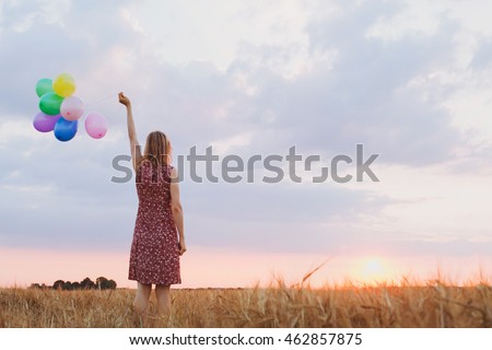 hope concept, emotions and feelings, woman with colorful balloons in the field, background