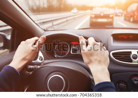traffic jam, driving car on highway, close up of hands on steering wheel in sunny day