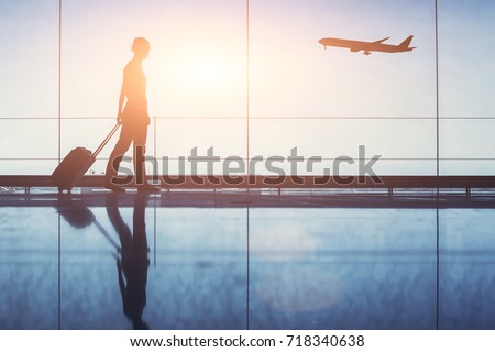 people traveling, silhouette of woman passenger with baggage in airport