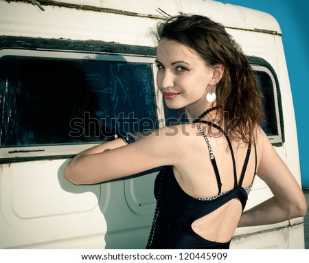 Beautiful young woman beside retro car. Travel and freedom concept.