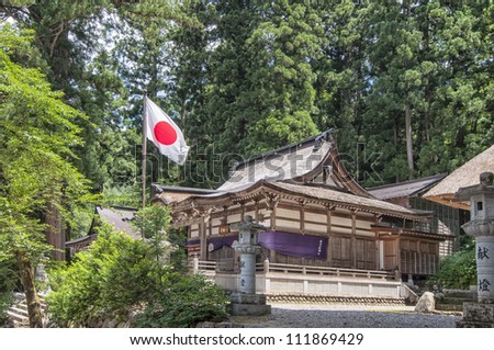 Shirakawago village temple with the Japanese flag