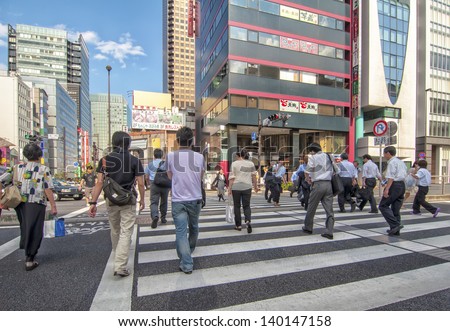 TOKYO,JAPAN-JULY 5: Unidentified people crossing in zebra crossing located in Hamamatsucho,Minato,Tokyo on July 5,2011 in Tokyo,Japan