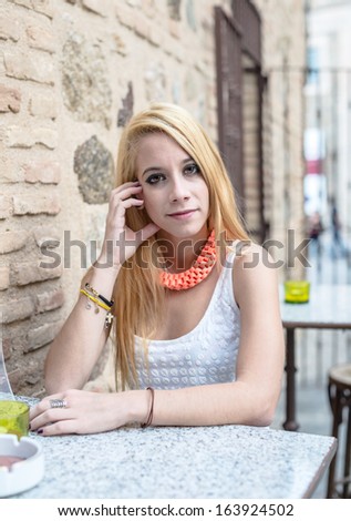 Young blonde girl in bar terrace
