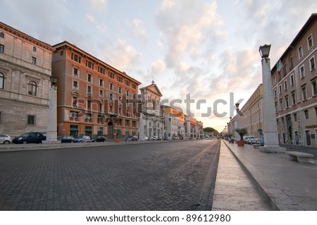 Sunrise on a street without people in the city of Rome, Italy